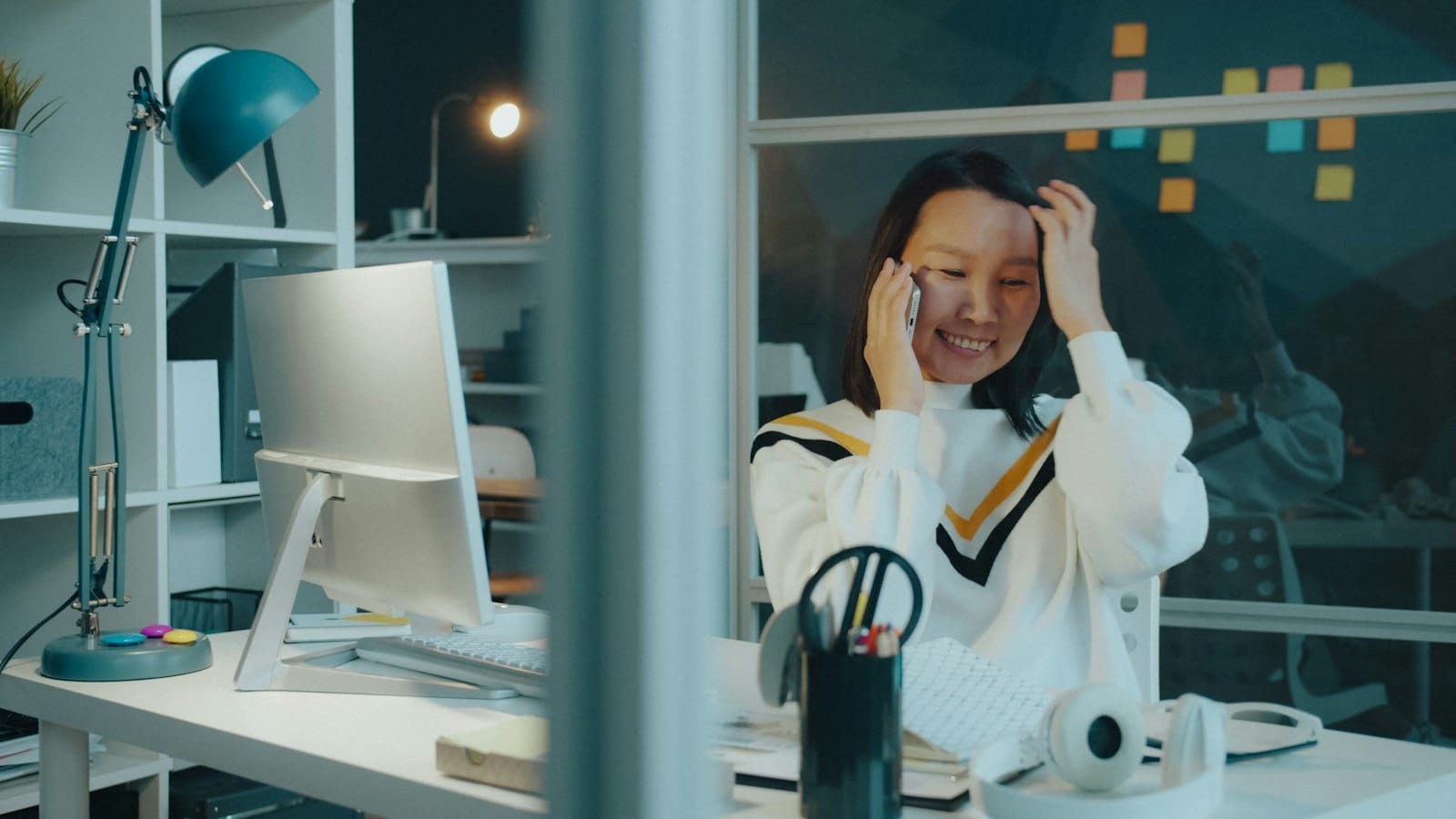 Employee speaking on the phone at her desk, representing confidential EAP hotline support